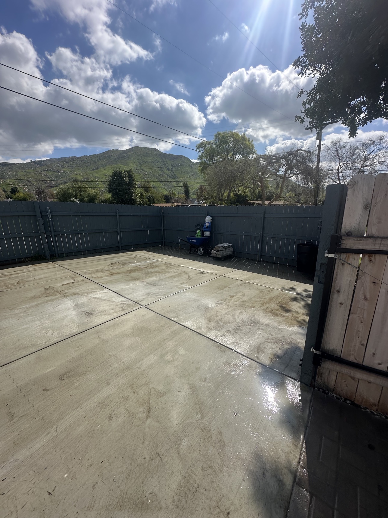 After: open swept concrete patio after Delta completed the Moreno Valley backyard cleanout