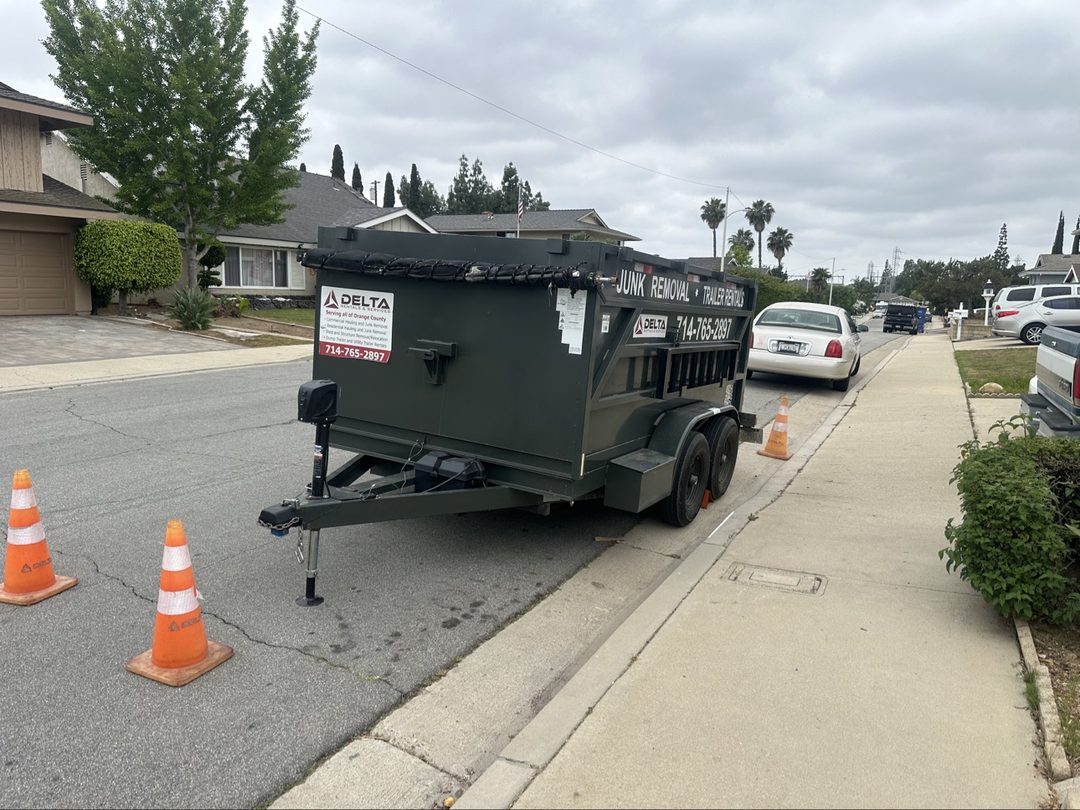 Delta dump trailer dropped on a Dana Point, California street with safety cones