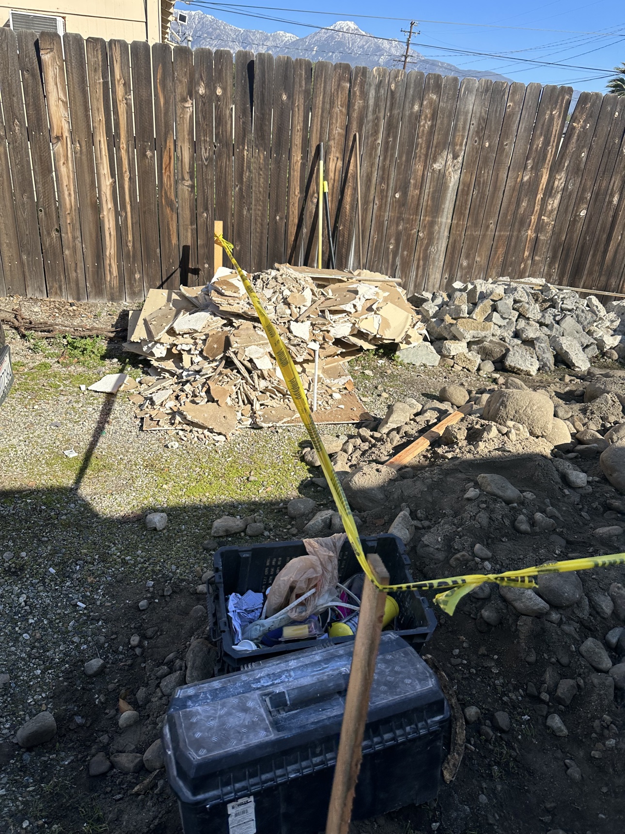 Yard debris and rubble awaiting removal at the Riverside project